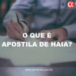 O que é apostila de Haia? (Foto de um homem assinando um documento e no canto superior direito a logo da emopresa Alpha Language Consulting)